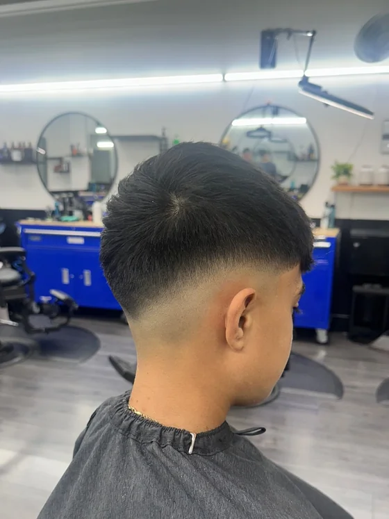 Low taper with textured fringe by barber Daniel Larrosa at Yovany Barbershop #3, North Fort Myers FL
